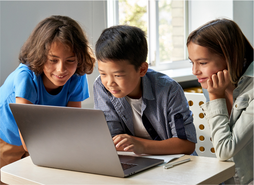 Diverse happy school kids using laptop computer together.